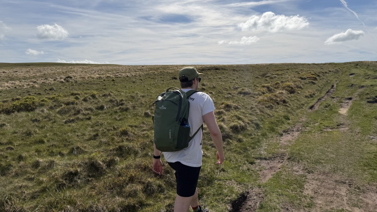 Fell The Original Tee worn on the move with a pack on a UK trail